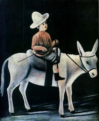Un niño pequeño montando un burro